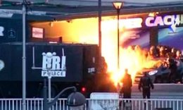 An explosion lights the front of a kosher supermarket as French police special forces launch their assault to free hostages.