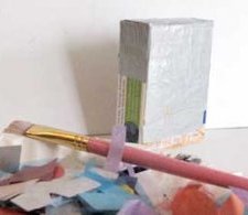 Decoupage the small cardboard boxes with recycled paper