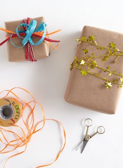 gold star tinsel garland wrapped around brown wrapping paper
