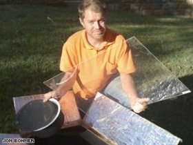 Inventor Jon Bohmer with the oven he has made out of a cardboard box.