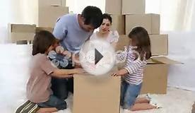 clip 561457: Parents and children moving house packing boxes